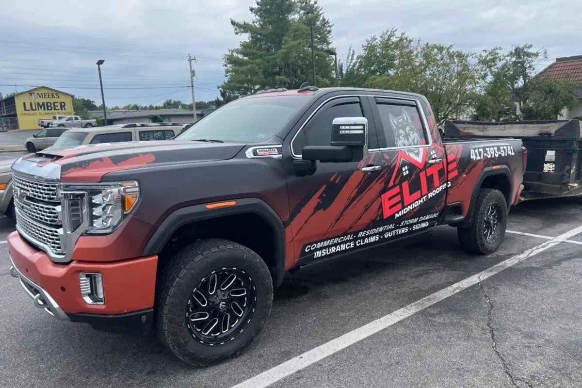 Elite Midnight Roofing branded work truck loaded for a roofing job