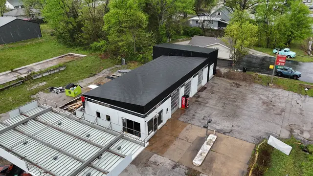 Aerial view of a commercial building with a new black metal roof