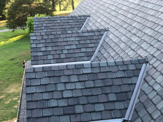 Shingle roof with metal flashing along a step-down and valley